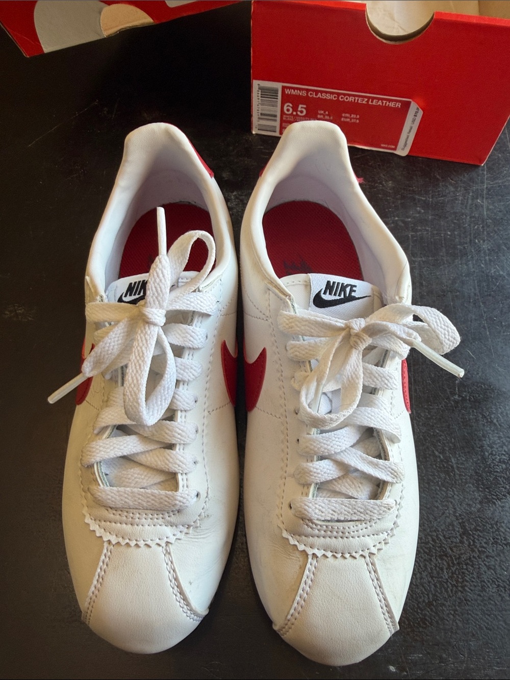 Nike Women’s Leather Sneakers in White with Red Swoosh